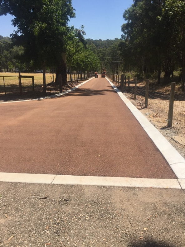 This is a photo of a hot spray & seal bitumen roadway which is in the process of being installed by Geelong Road Tech